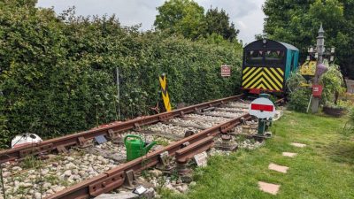 Retired Engineer Constructs 50-Foot Mini Railway in Backyard